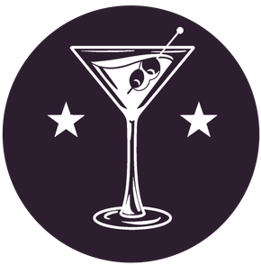 Cocktail glass with olives and stars on a dark purple background.