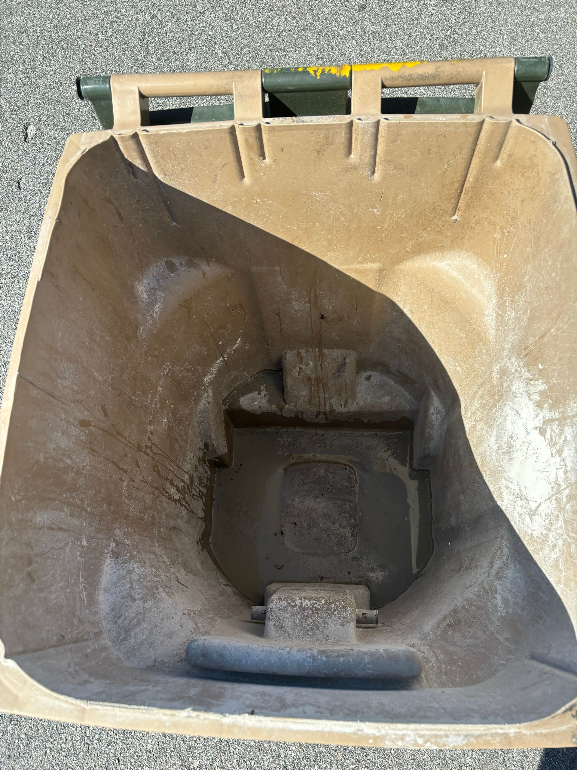 A man is sitting in a chair looking at his cell phone.