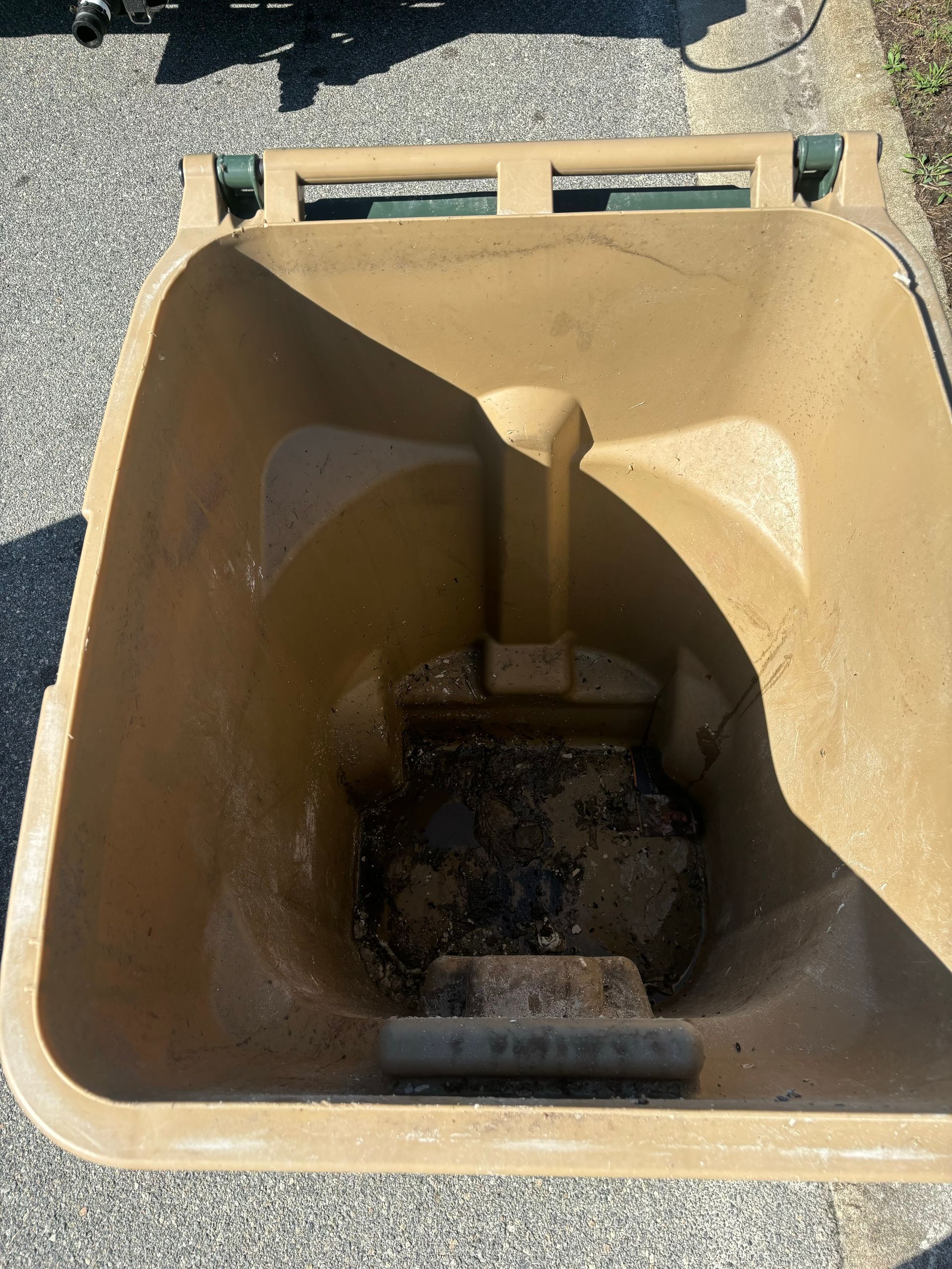 A man is sitting in a chair looking at his cell phone.