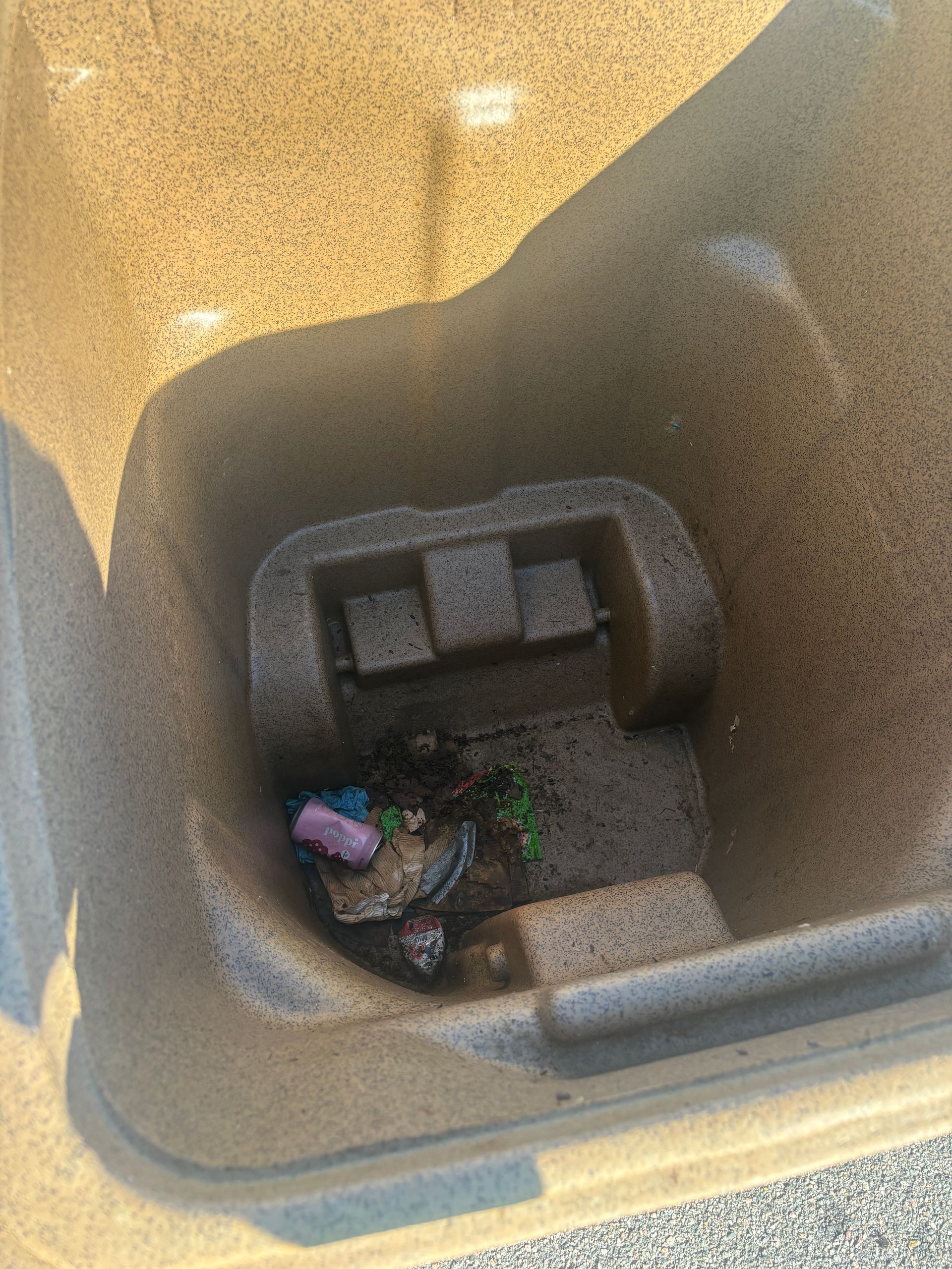 A man is sitting in a chair looking at his cell phone.