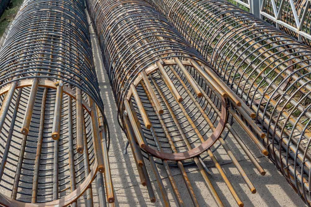 A Bunch of Metal Pipes Sitting on Top of Each Other — DnA Steel Direct in Ciccone, NT