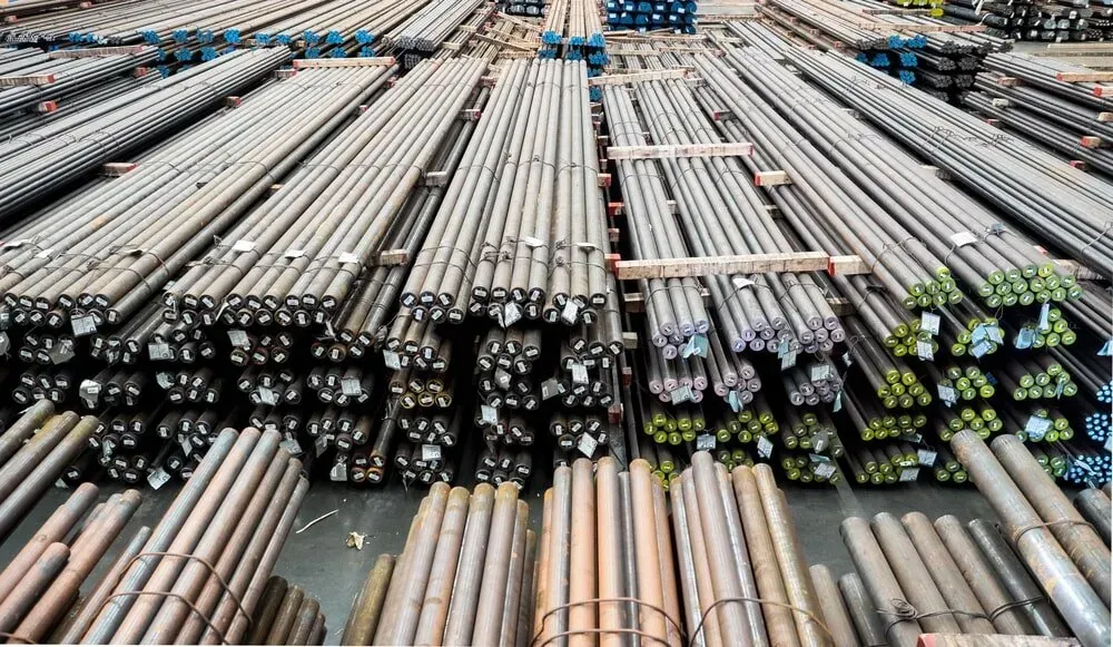 A Bunch of Metal Pipes Are Stacked on Top of Each Other in a Warehouse — DnA Steel Direct in Ciccone, NT