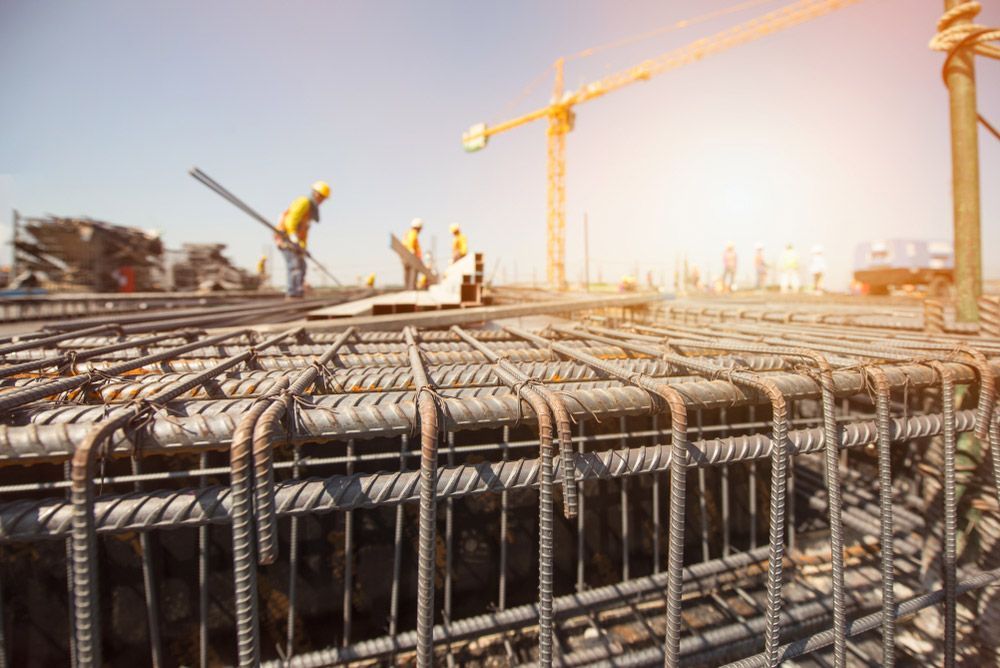 A Construction Site With Workers and a Crane in the Background — DnA Steel Direct in Ciccone, NT