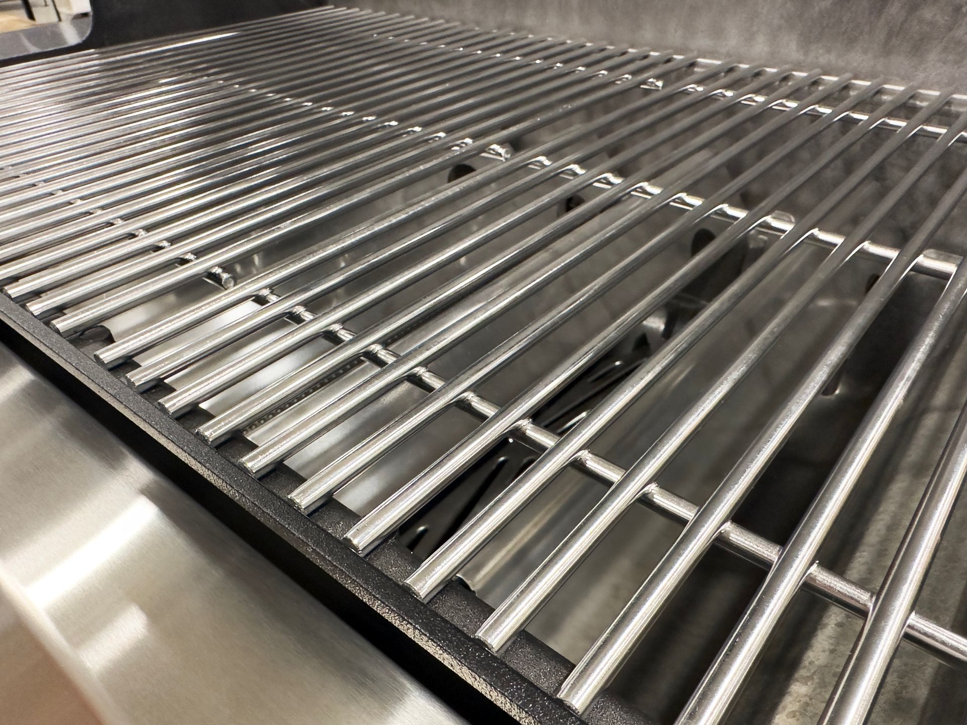 A close up of a stainless steel grill grate