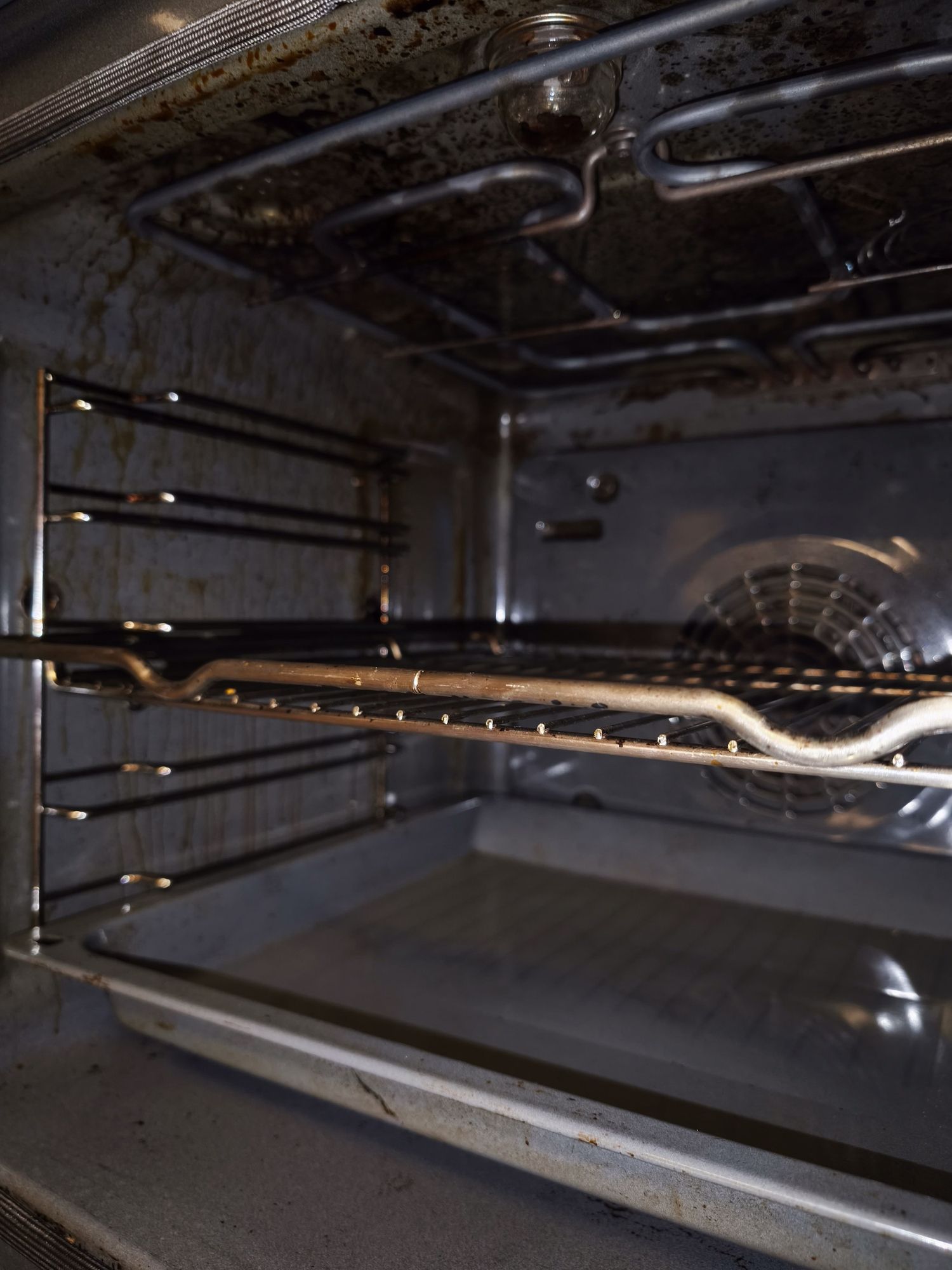 The inside of an oven is very dirty and needs to be cleaned