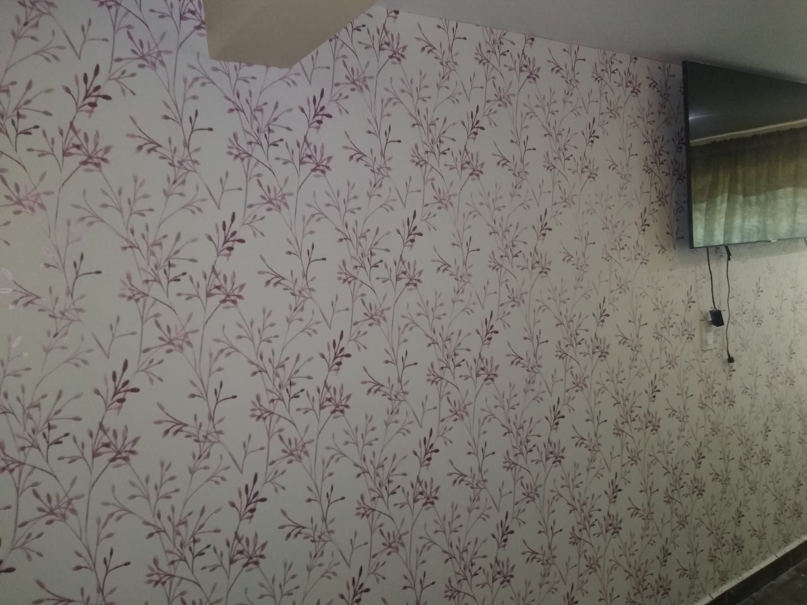 Pared con estampado floral blanco y espejo.