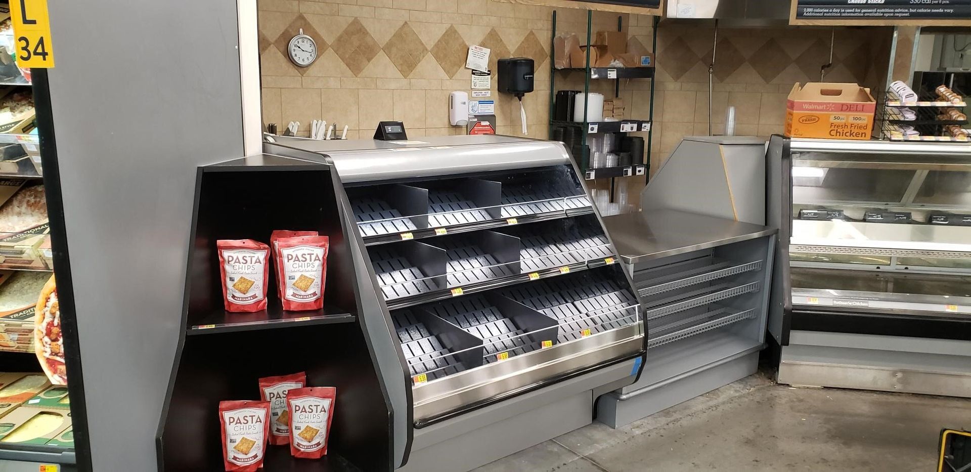 The inside of a grocery store with a display case and a counter.