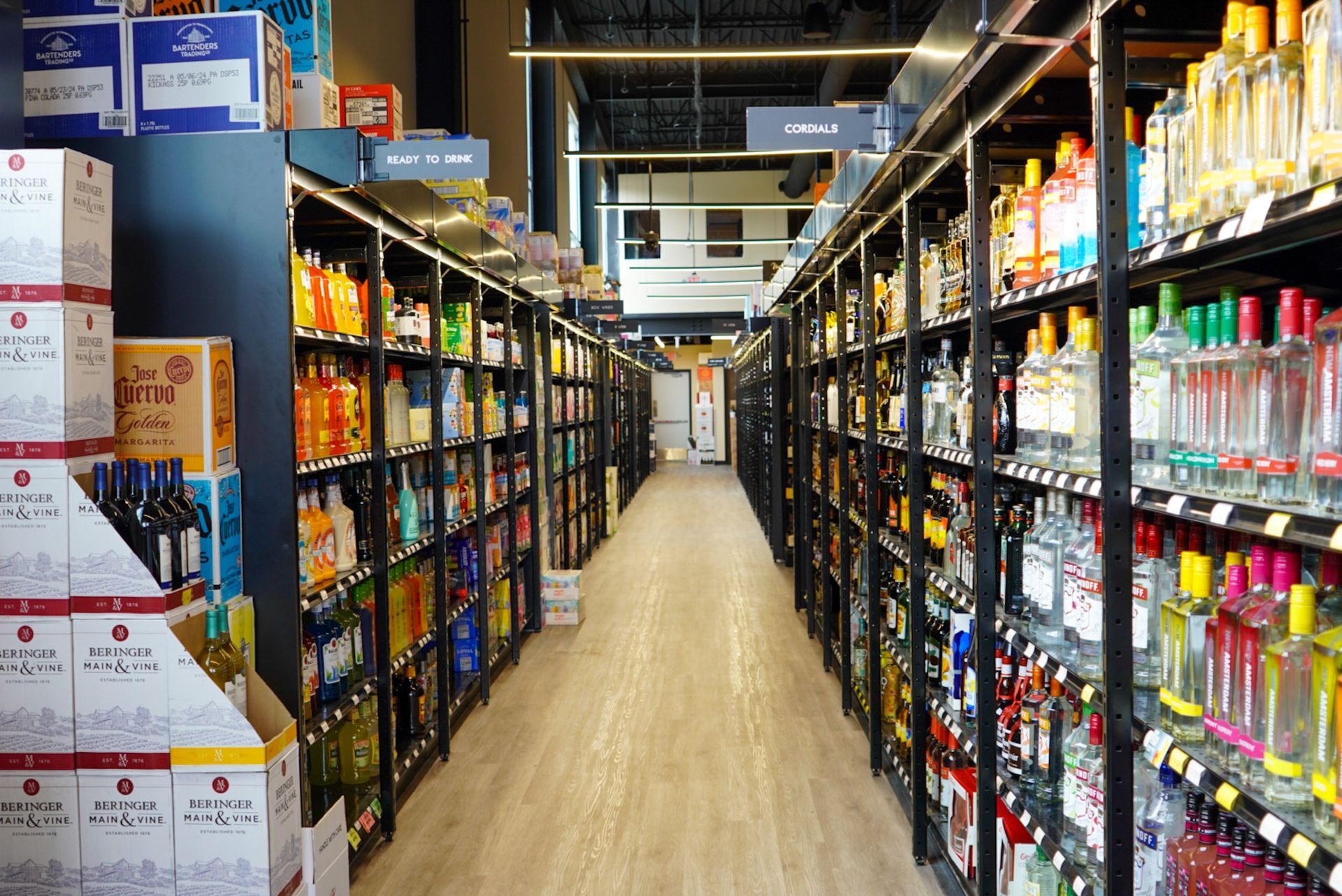 A long aisle in a liquor store filled with lots of bottles