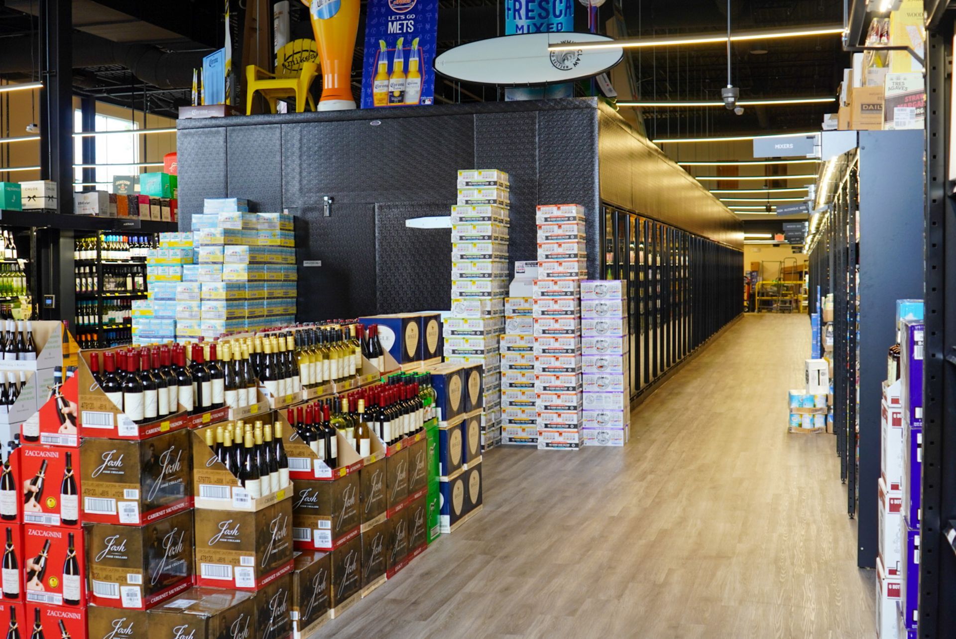 A long aisle in a liquor store filled with lots of bottles and boxes.