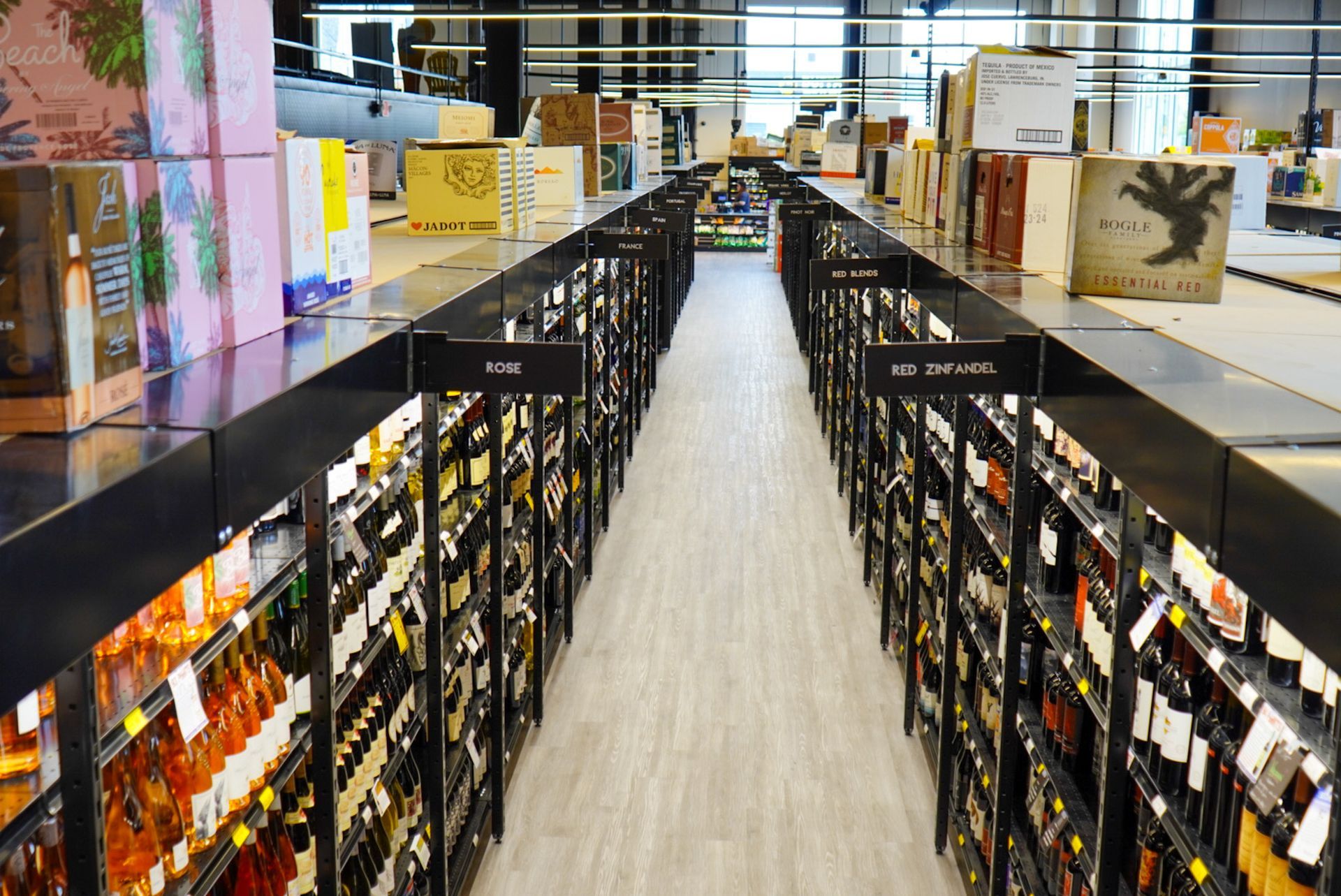 A long aisle in a store filled with lots of bottles