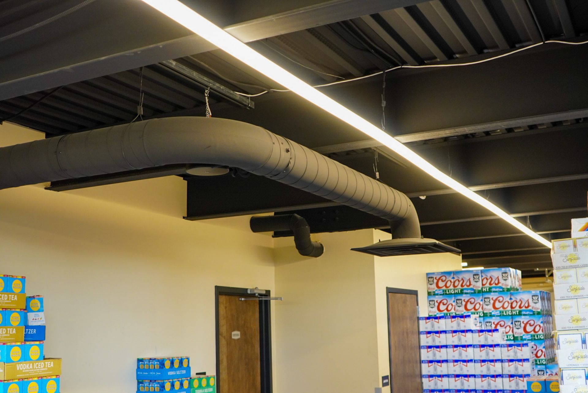 A room with a ceiling that has a lot of pipes hanging from it.
