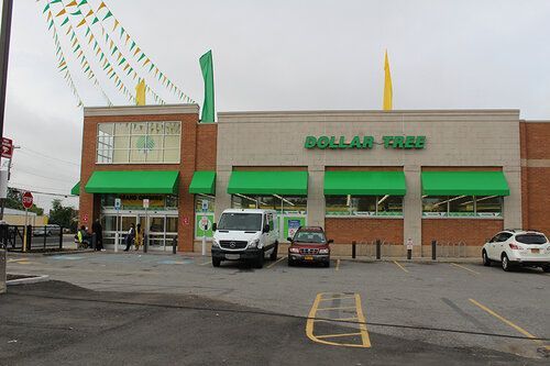 A dollar tree store with cars parked in front of it