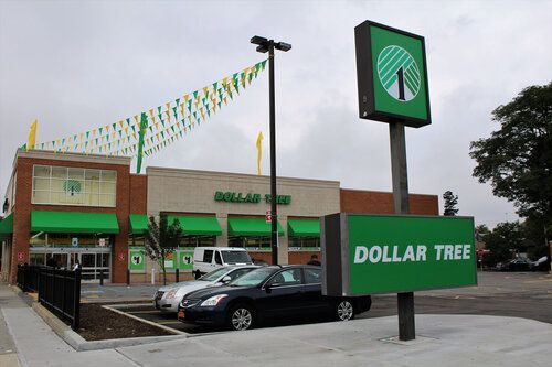 A dollar tree store with cars parked in front of it