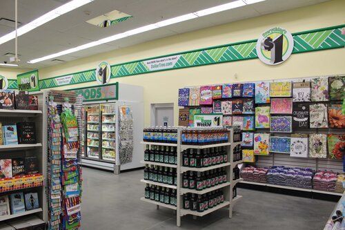 The inside of a dollar store filled with lots of shelves and bottles.