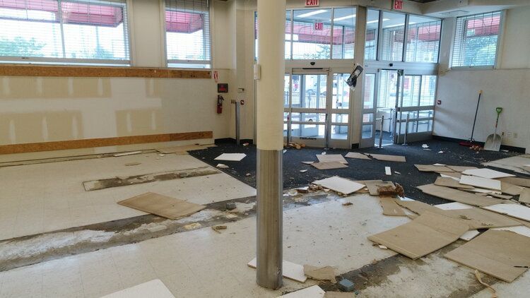 An empty room with a lot of cardboard laying on the floor.