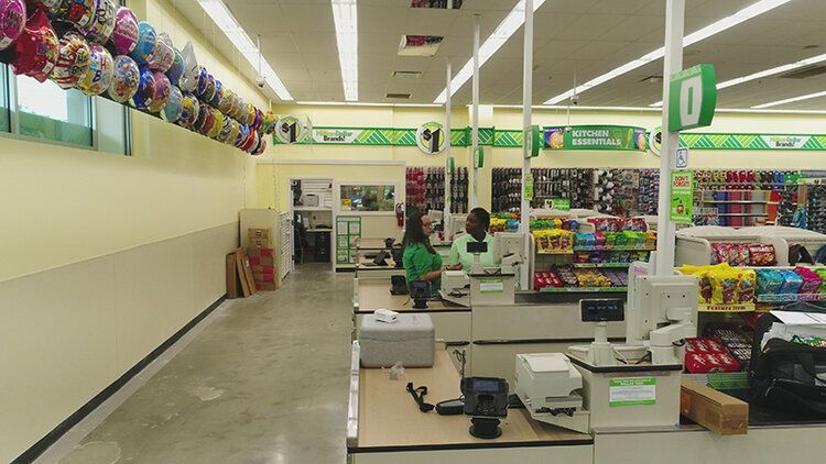 A woman is standing at a cash register in a store.