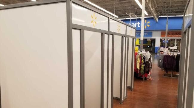 A row of changing rooms in a walmart store.