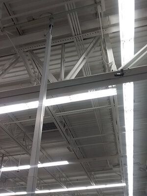 The ceiling of a building with a lot of lights hanging from it.