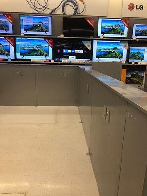 A row of lg televisions are on display in a store.