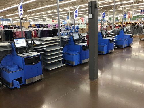 A row of blue cash registers in a store.