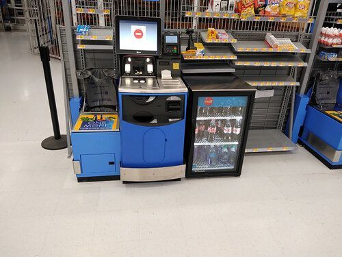 There is a cash register in the middle of a store.