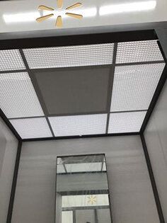 A bathroom with a ceiling fan and a mirror.