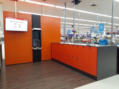 A store with an orange counter and a tv on the wall.