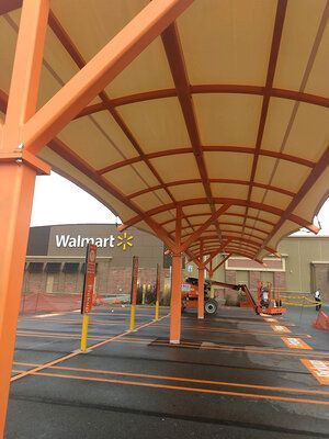 A walmart parking lot with a canopy over it