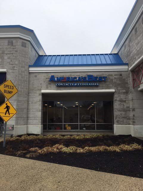 A store front with a speed bump sign in front of it