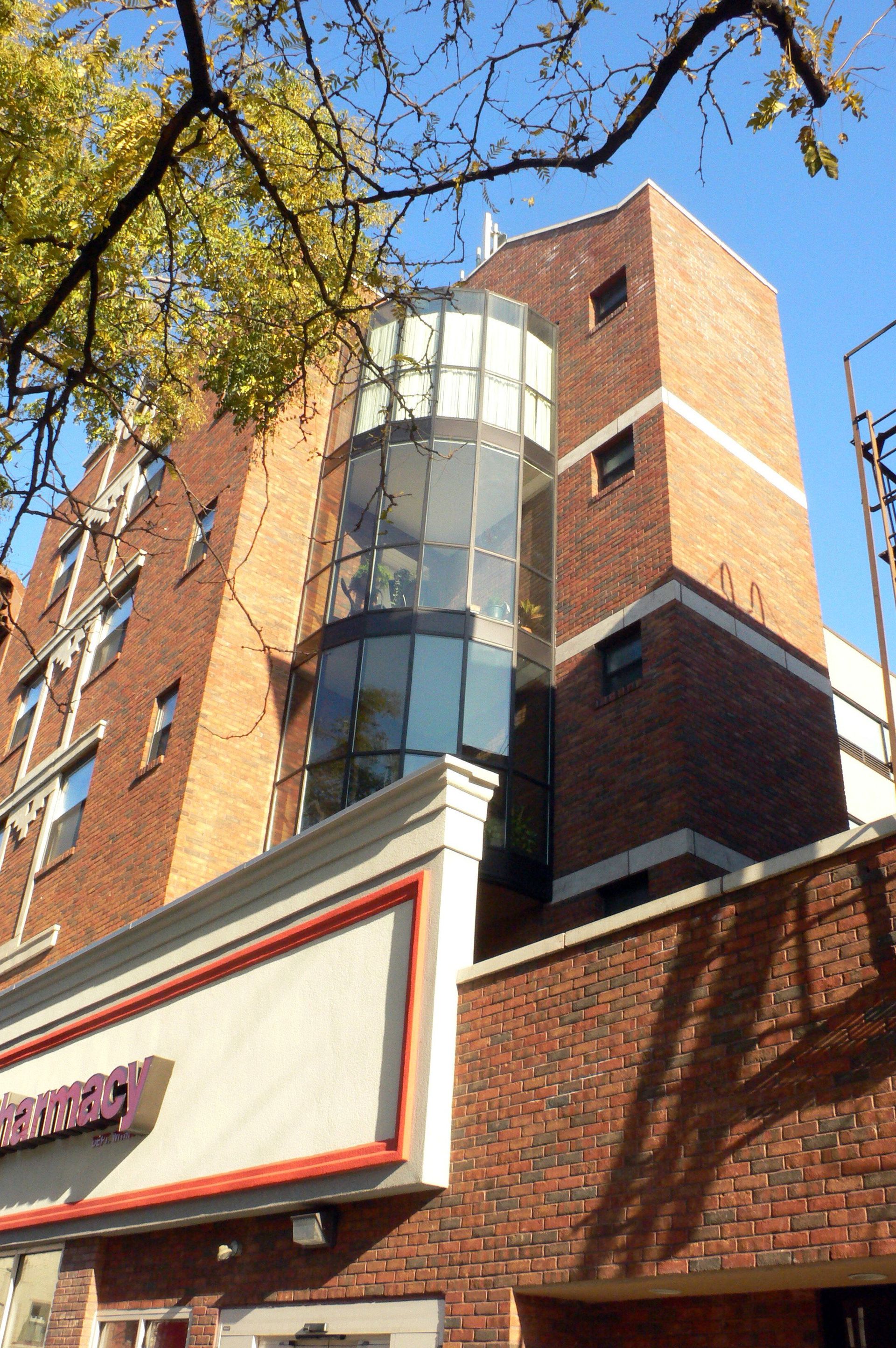 A brick building with a purple sign that says ' embassy ' on it