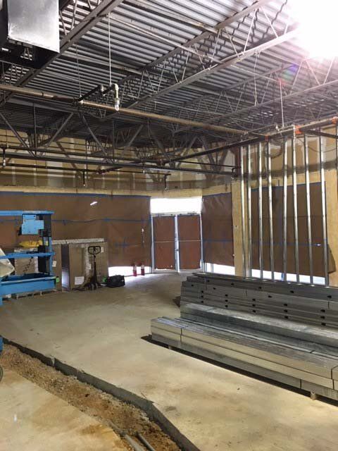 A large room with a lot of metal stacked on the floor