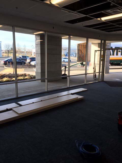 A large empty room with a lot of windows