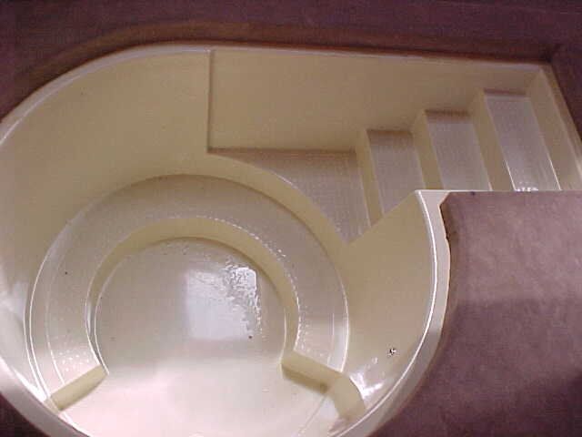 A white plastic container with a spiral design on it