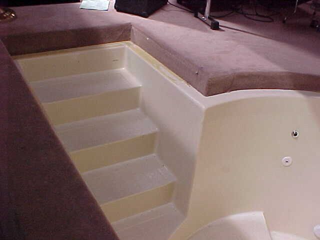 A jacuzzi tub with stairs leading up to it