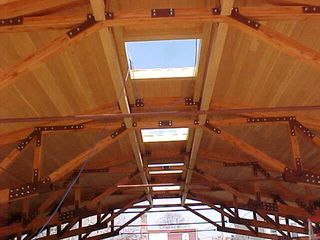 A wooden structure with a skylight in the middle of it