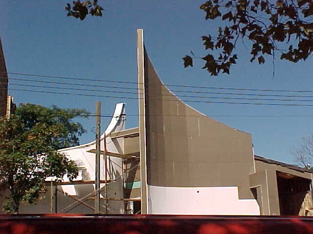 A building that is being built with a blue sky in the background
