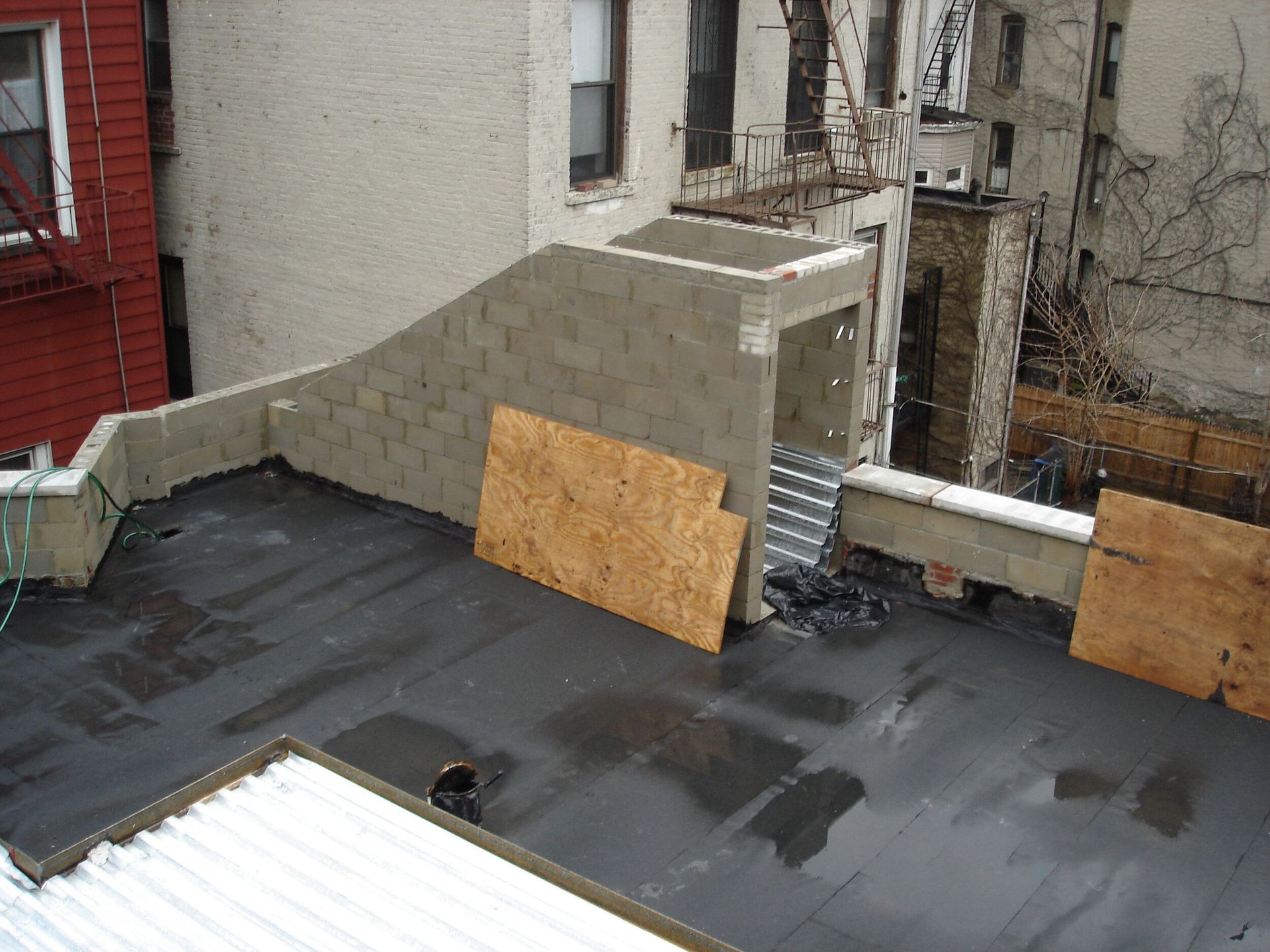A roof with a few pieces of plywood on it