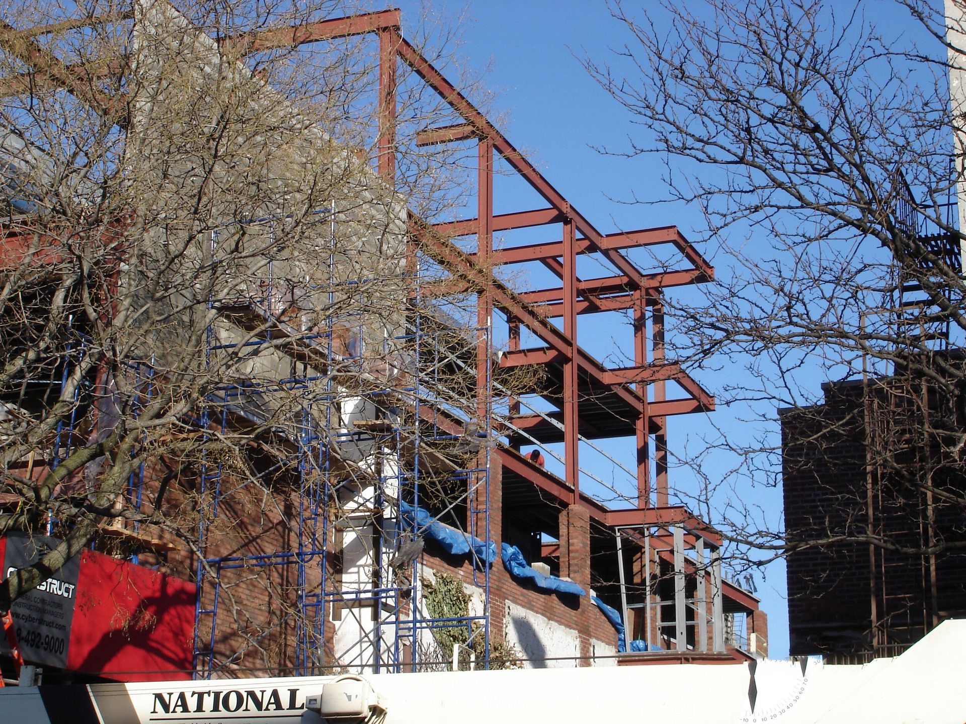 A national truck is parked in front of a building under construction