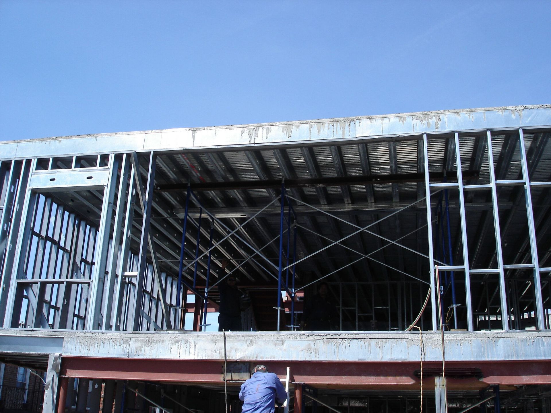 A building under construction with a blue sky in the background