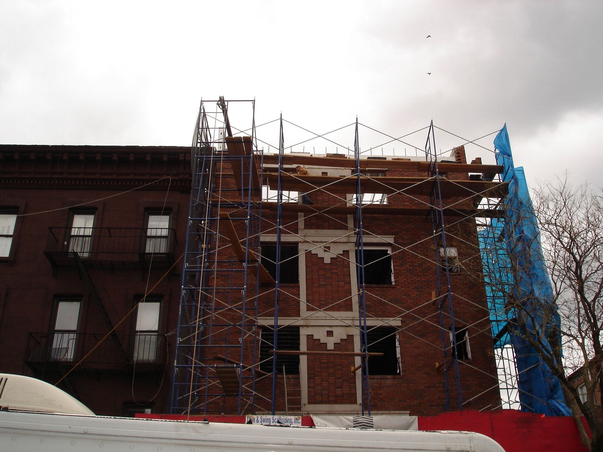 A brick building under construction with scaffolding around it