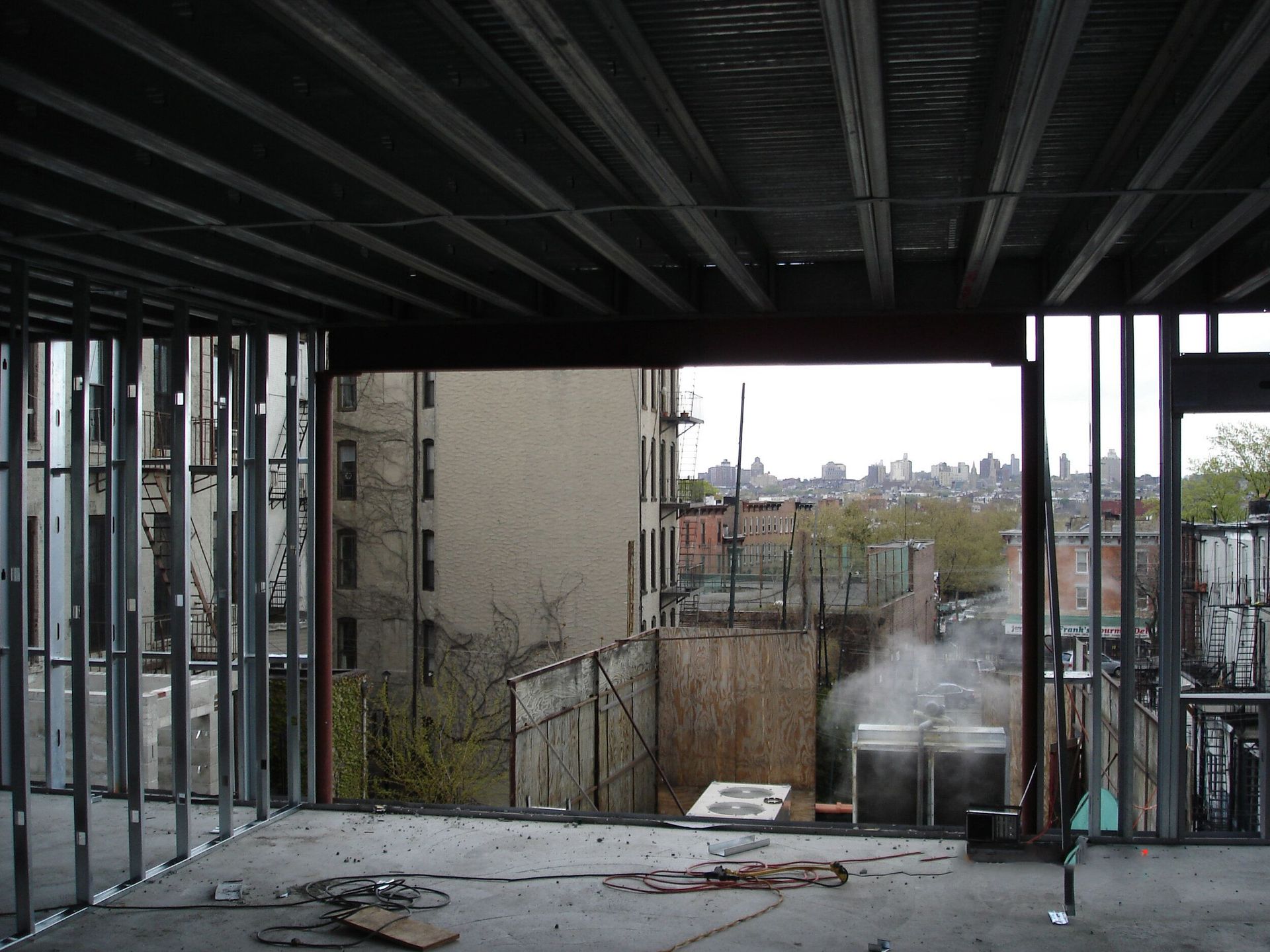 A building under construction with a view of the city