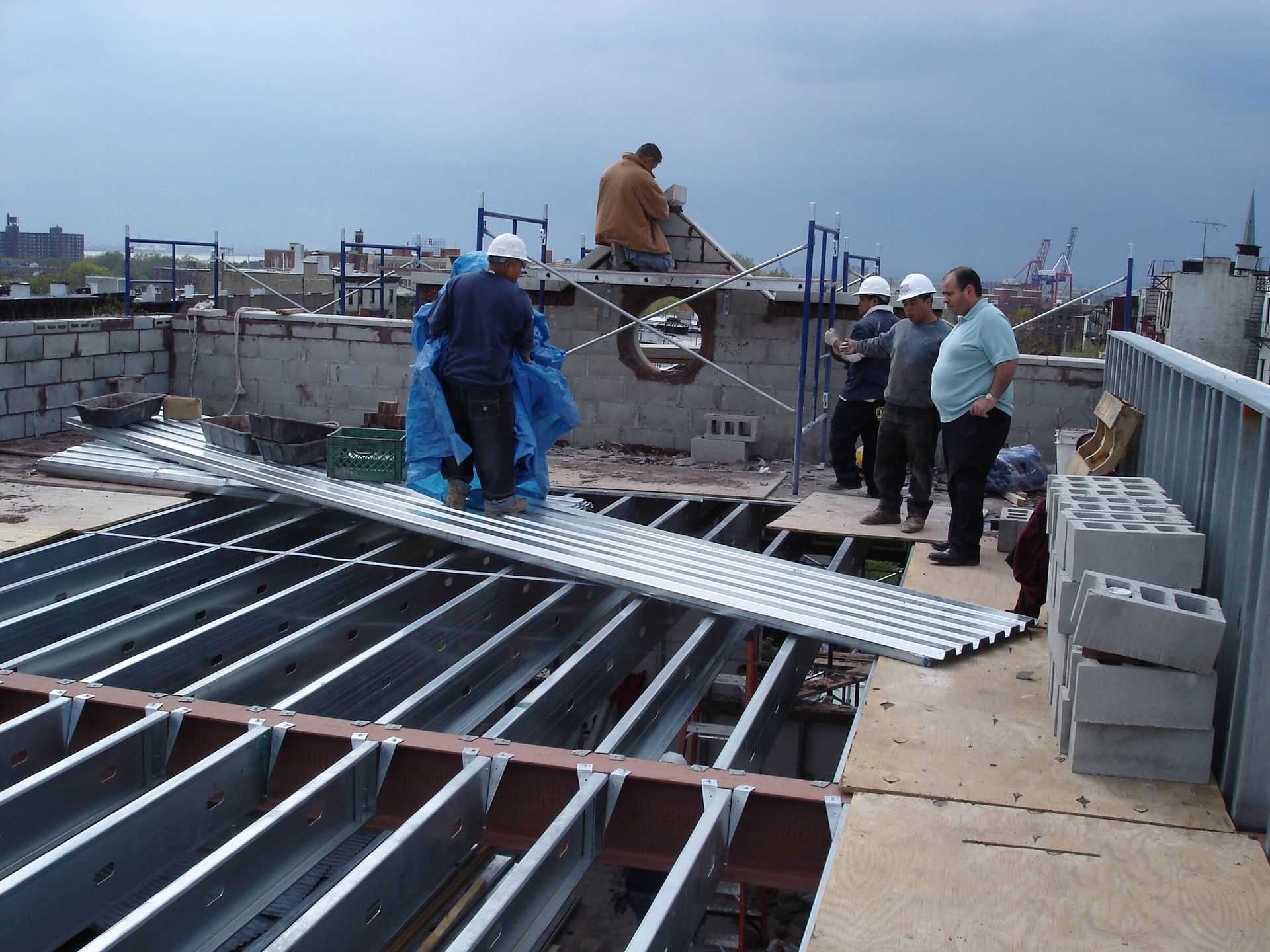 A group of construction workers are working on a roof