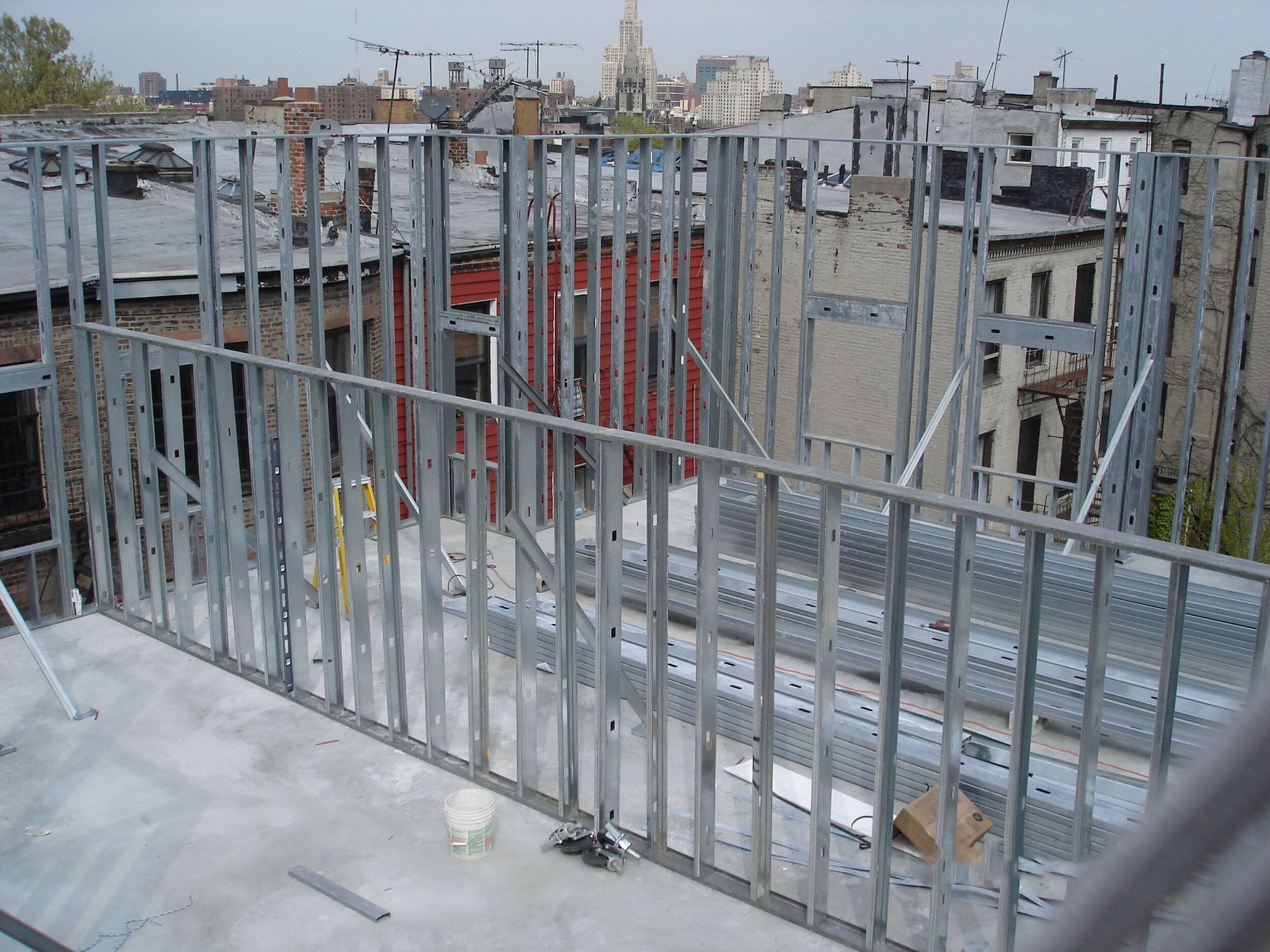 A metal fence is surrounding a building under construction