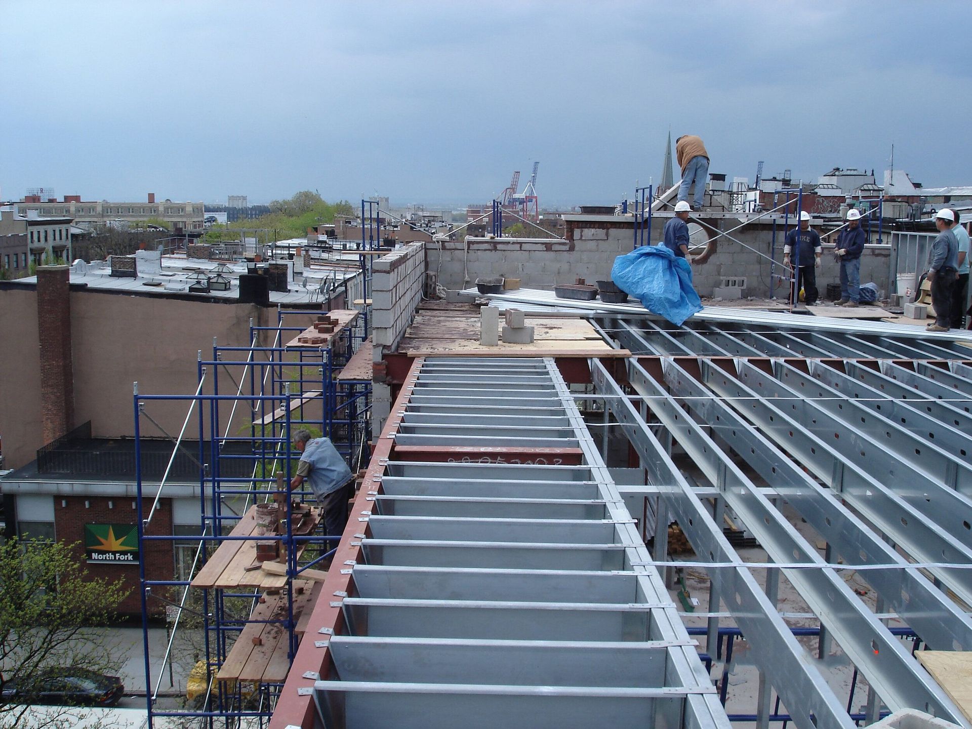 A group of people are working on the roof of a building