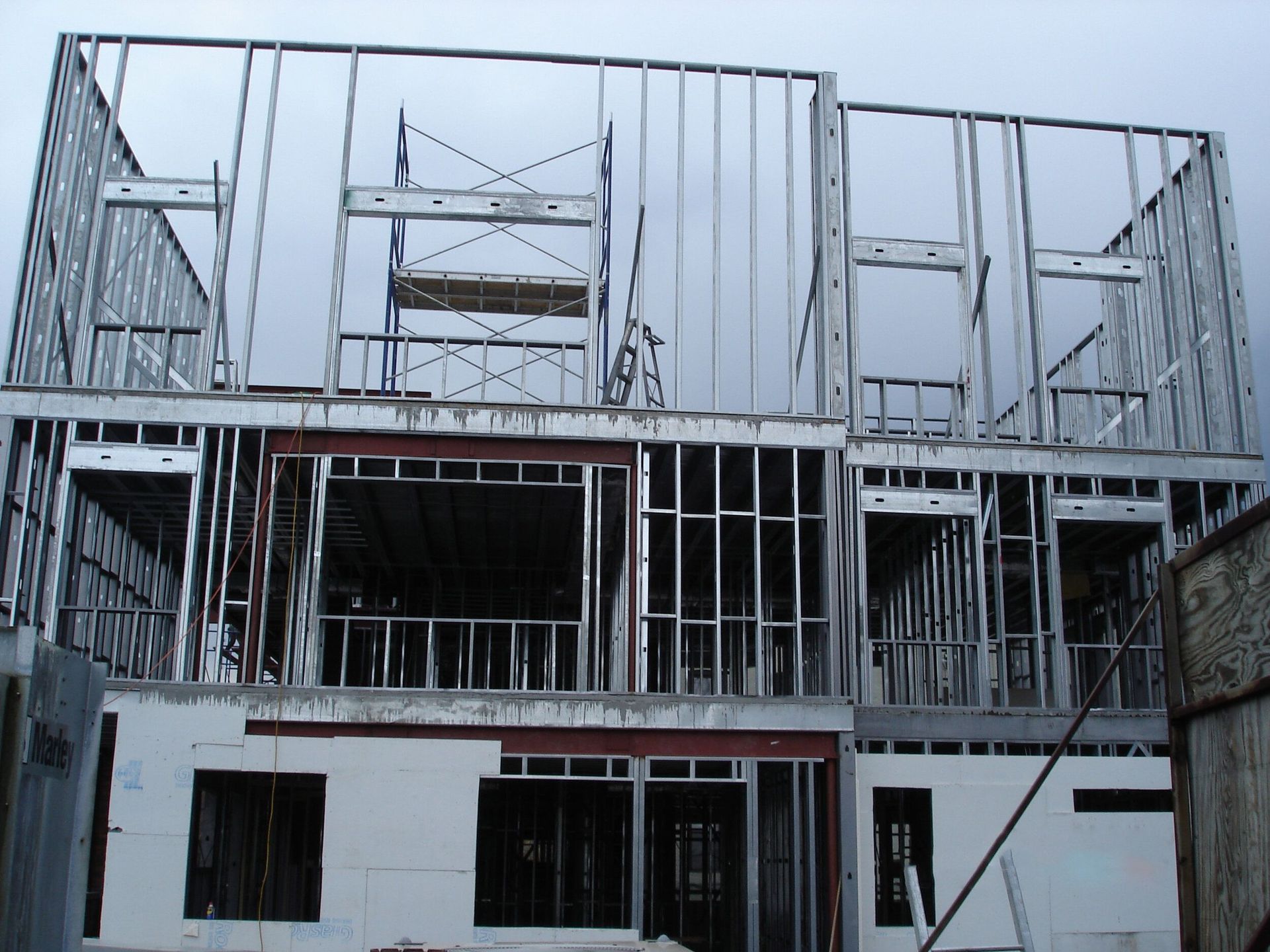 A building under construction with scaffolding on the side