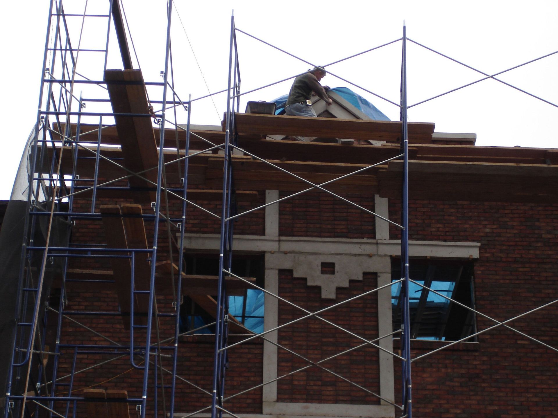 A brick building under construction with scaffolding around it