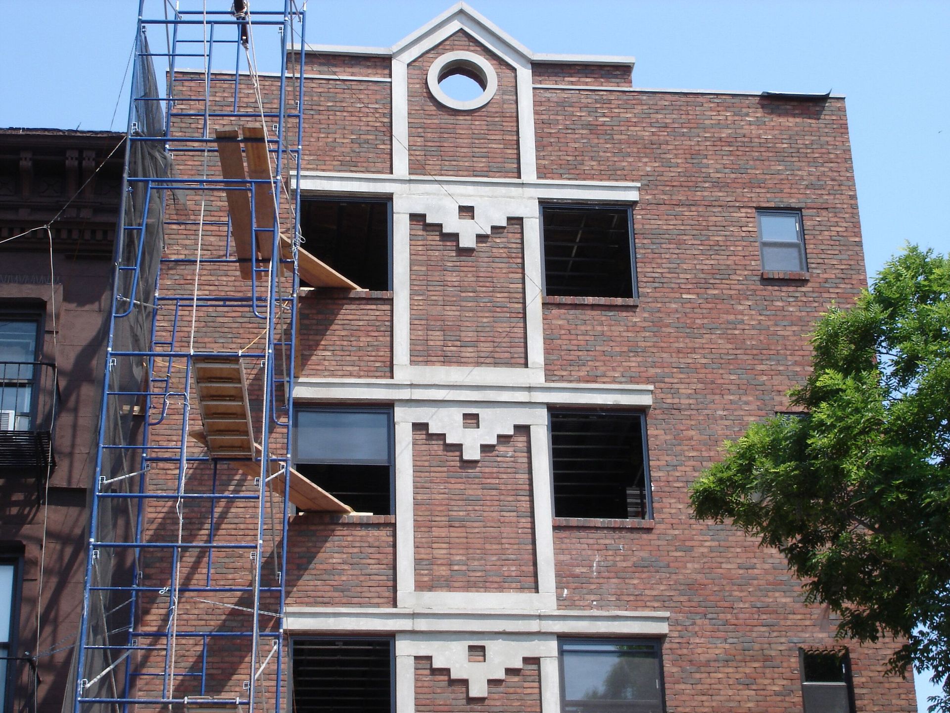 A brick building under construction with scaffolding around it