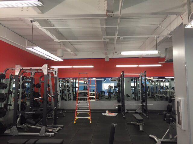 A gym with a ladder in the middle of it