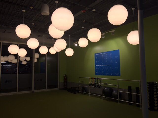 A room with lots of lights hanging from the ceiling