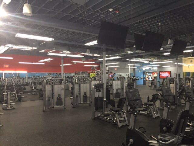 A gym filled with lots of exercise equipment